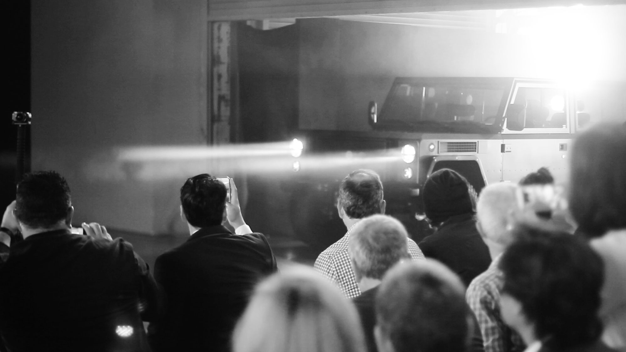 The Bollinger B1 2 door being revealed in 2017, coming through lights and fog.