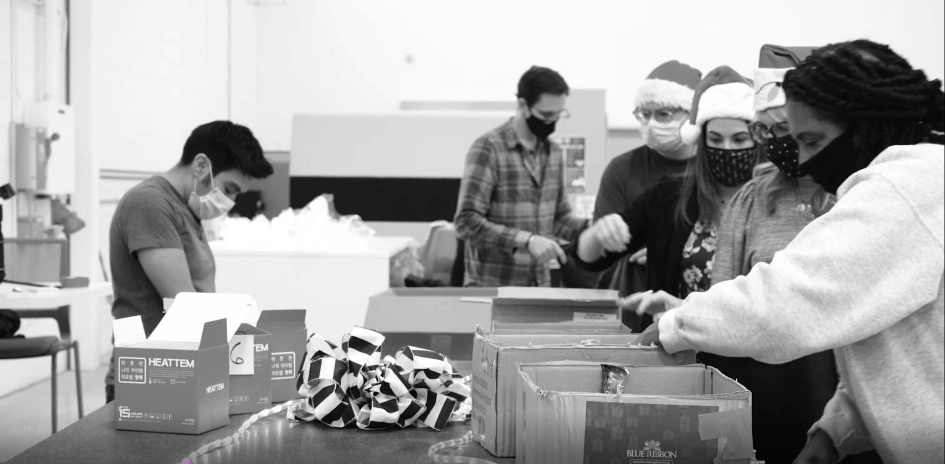 The team wrapping presents to take to a charitable organization.